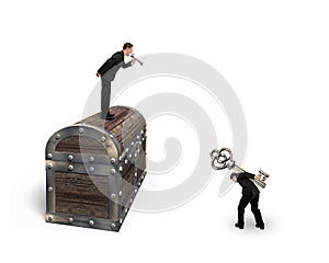 Man on treasure chest command employee carrying key