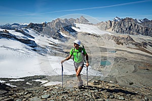 Man trekking in the Alps in a beautiful sunny day. Grand Paradiso National Park. Italy