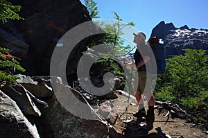 Man trekking with big backpack in Nahuel Huapi national park, Backpacker on hiking trail in Andes mountains of Patagonia photo