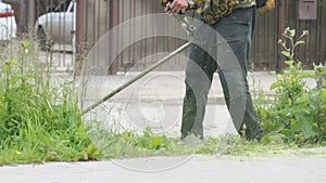 Man trimming grass in a garden using a lawnmower