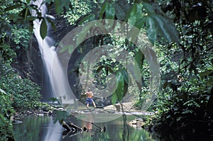 Man at tropical waterfalls, Trinidad