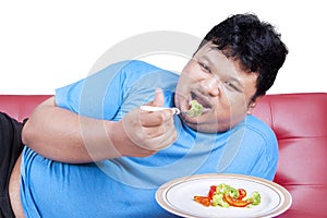 Man try to diet by eating vegetable 2