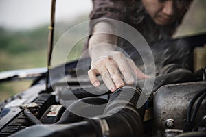 Man try to fix a car engine problem on a local road Chiang mai Thailand