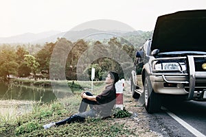 Man try to fix a car engine problem on a local road Chiang mai Thailand