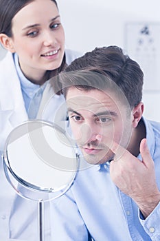Man trying on contact lens