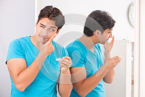 The man trying contact lenses at home