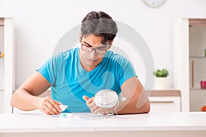 The man trying contact lenses at home