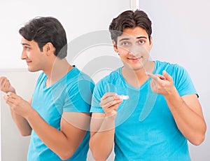 Man trying contact lenses at home