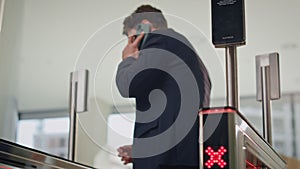 Man trying enter office turnstile using smartwatch. Calling man unlocking gates