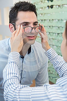 man trying on new eyeglasses with designer frames