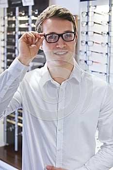 Man Trying On New Glasses At Opticians
