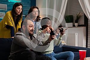 Man trying to beat multi ethnic friends at online games challange