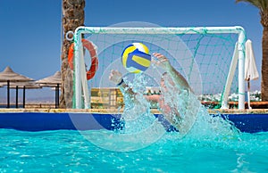 Man trying to catch the ball in pool playing water polo