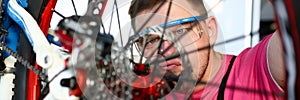 Man trying to deal with broken bicycle mechanism.