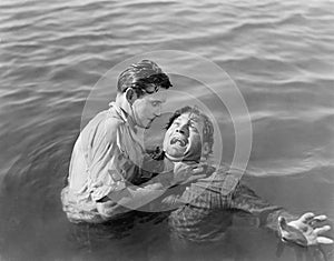 Man trying to drown and kill a man photo