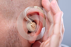 Man Trying To Hear After Wearing Hearing Aid