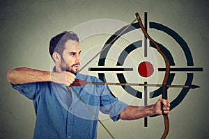 Man trying to hit a target with bow and arrow