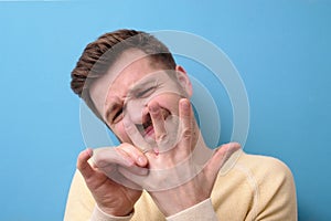 Man trying to put off wedding band from his finger.