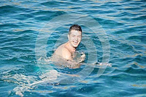 Man trying to swim butterfly in the sea