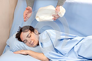 Man trying to wake up a woman using a paper bag