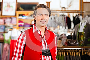 Man is trying Tracht or Lederhosen in a shop photo