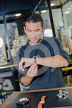 Man trying on watch on jewellers