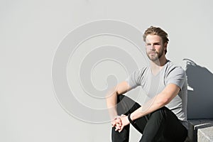 Man in tshirt relax on grey wall, fashion