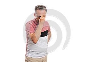 Man in tshirt touching forehead thinking gesture with copyspace