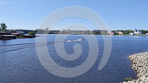 Man tubing behind motorboat on river