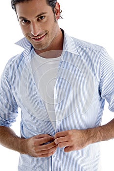 Man tucking his shirt buttons