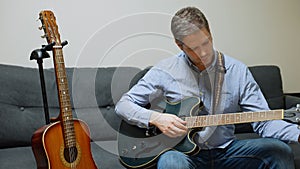 Man tuning guitar.