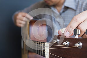 Man tuning guitar
