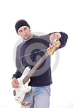 Man tuning a guitar with adjustments