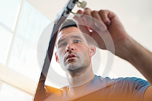 Man Tuning His Acoustic Guitar Before Playing Music