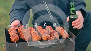 Man Turning Barbecue Grill Meat Outdoors