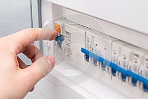 Man turning on the fuse box