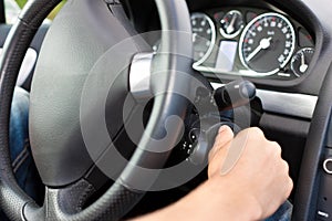 Man turning the ignition key of his car