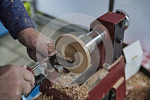 Man turning wooden candle stands on a wood lathe