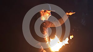 Man turns hot fireballs in front of face. Dangerous fire tricks. Play with fire