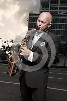 Man in a tux playing a saxophone