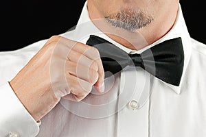 Man In Tux Straightens Bowtie, One Hand