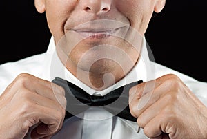 Man In Tux Straightens Bowtie, Two Hands