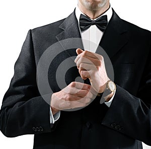 Man in tuxedo puts on watch