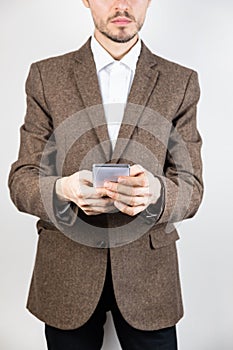 Man in tweed jacket with a mobile phone.