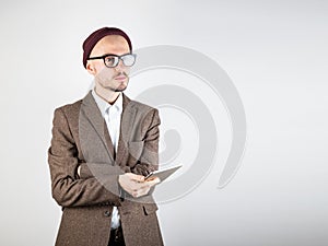 Man in tweed jacket with a tablet computer.