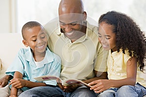 Man and two children sitting in living room