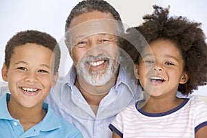 Man and two young children smiling