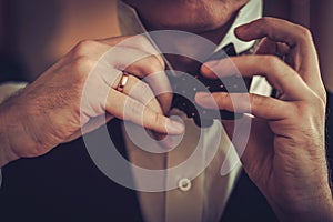 Man tying custom made bowtie