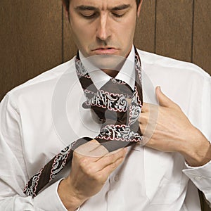 Man tying his necktie.