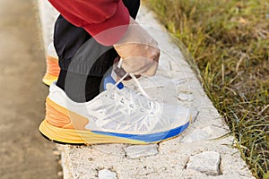 Man Tying Jogging Shoes